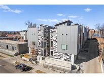 Modern building exterior with gray and white panels, balconies, and clean architectural lines at 2321 Eliot St, Denver, CO 80211