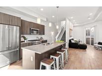 Modern kitchen features a center island with barstool seating and stainless steel appliances at 2321 Eliot St, Denver, CO 80211