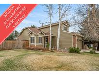 Charming home with a well-manicured lawn, mature trees, and inviting curb appeal at 16309 Hedgeway Dr, Parker, CO 80134