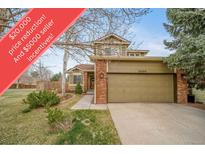 Charming two-story home with a two-car garage, beautiful trees, and manicured landscaping at 16309 Hedgeway Dr, Parker, CO 80134