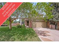 Charming home with a well-maintained lawn, mature trees, and a convenient two-car garage at 16309 Hedgeway Dr, Parker, CO 80134
