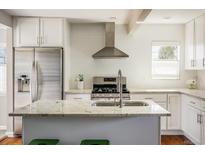 Bright kitchen with granite countertops, stainless steel appliances, and a large island at 190 S Canosa Ct, Denver, CO 80219
