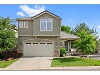 Charming two-story home boasts a manicured front lawn, two-car garage, and inviting curb appeal at 12054 E Lake Cir, Greenwood Village, CO 80111