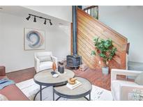 Cozy living room featuring wood burning stove, modern furniture, and decorative art at 1595 Macarthur Dr, Boulder, CO 80303
