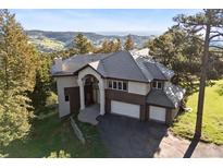 Beautiful two-story home featuring a neutral color palette, tile roof, and picturesque mountain views at 23655 Currant Dr, Golden, CO 80401
