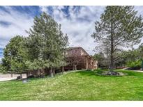 A large house with two stories and a well-maintained lawn with mature trees at 8707 Windhaven Dr, Parker, CO 80134