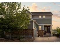 Beautiful two-story home featuring stone accents, neutral siding and a well-maintained front yard landscape at 3871 Starry Night Loop, Castle Rock, CO 80109