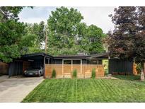 Charming single-story home with a modern design, landscaped front yard, and a covered carport at 2525 S Meade St, Denver, CO 80219