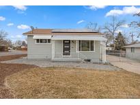 Charming single-story home with solar panels and a covered front porch at 1100 S Quitman St, Denver, CO 80219