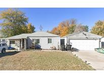 Cozy single-story home with a detached two-car garage and mature trees enhancing the property at 1925 S Irving St, Denver, CO 80219