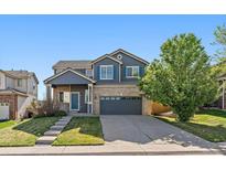Charming two-story home with a well-maintained yard and attached two car garage at 2404 S Genoa Way, Aurora, CO 80013