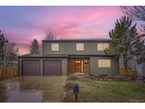 Charming two-story home with a well-manicured lawn, complemented by a spacious three-car garage at 11864 E Idaho Dr, Aurora, CO 80012