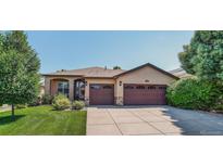 Charming single-story home featuring a well-manicured lawn and a two-car garage at 8582 E 148Th Ln, Thornton, CO 80602