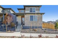 Charming two-story home with a stone and siding exterior, plus a landscaped front yard at 21185 E 62Nd Ave, Aurora, CO 80019