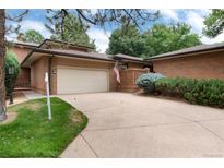 Brick ranch home with attached garage and landscaped yard at 6100 W Mansfield Ave # 24, Denver, CO 80235