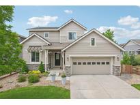 Charming two-story home with a well-maintained front yard and two-car garage, inviting curb appeal at 16226 W 94Th Dr, Arvada, CO 80007