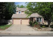 Charming two-story home with a two-car garage and mature trees at 14503 E Wagon Trail Dr, Aurora, CO 80015