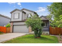 Charming two-story home with gray siding, brick accents, and a well-manicured front yard at 4333 E Bennington Ave, Castle Rock, CO 80104