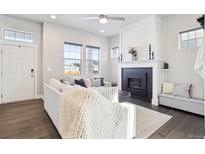 Bright living room with fireplace and comfy seating at 10350 E 57Th Pl, Denver, CO 80238