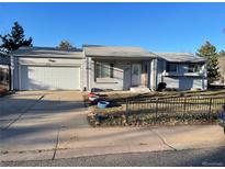 Charming single-story home with an attached two-car garage and well-kept front yard at 16289 E Wagontrail Dr, Aurora, CO 80015