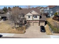 Beautiful two-story home showcasing a brick-accented facade and a spacious three-car garage at 4765 Larksong Dr, Castle Rock, CO 80109