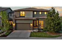 Charming two-story home featuring a stone-accented facade, well-maintained landscaping, and a convenient two-car garage at 481 Meadowleaf Ln, Highlands Ranch, CO 80126