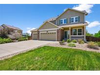Charming two-story home featuring a three-car garage, well-maintained landscaping, and inviting front porch at 35 N Newcastle Ct, Aurora, CO 80018