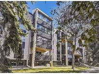 Modern condo with black balcony bars and a view of trees at 6940 E Girard Ave # 307, Denver, CO 80224