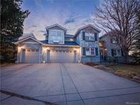 Charming two-story home features a three-car garage and a well-manicured front yard at 126 Mc Intyre Circle, Golden, CO 80401