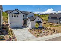 Charming two-story white home with a well-manicured front yard and a spacious driveway under a bright, sunny sky at 3898 Descent St, Castle Rock, CO 80108