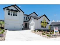 Beautiful modern farmhouse with white siding, black trim, and a well-manicured front yard at 3898 Descent St, Castle Rock, CO 80108