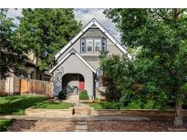 Charming home with a gray exterior, landscaped front yard, and inviting front porch at 424 N Clarkson St, Denver, CO 80218