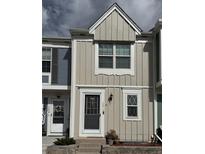 Charming two-story townhouse with light tan vertical siding and white trim at 10810 Summerset Way, Parker, CO 80138