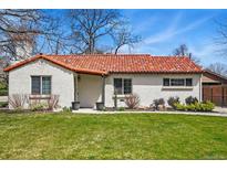 Charming single-story home with a red tiled roof, well-maintained lawn, and inviting curb appeal at 796 Ivanhoe St, Denver, CO 80220