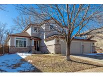 Two-story house with a two-car garage and landscaping at 4236 Lark Sparrow St, Highlands Ranch, CO 80126