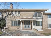 Brick ranch home with a covered entry and mature landscaping at 3257 S Pontiac St, Denver, CO 80224