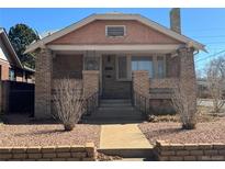 Charming brick home featuring a quaint front porch and detailed brickwork at 1992 S Lincoln St, Denver, CO 80210