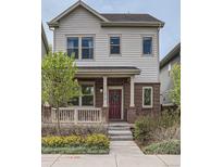 Charming two-story home boasts brick accents, a cozy front porch, and well-manicured landscaping at 11270 E 26Th Ave, Aurora, CO 80010