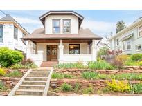 Charming two-story home with a terraced front yard and inviting covered porch at 1220 S Vine St, Denver, CO 80210