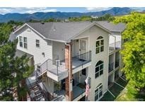 Inviting condo showcases multiple balconies, brick accents, metal railings and mountain views, ideal for outdoor living at 1670 S Deframe St # B2, Lakewood, CO 80228