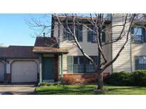 Charming home with a well-manicured lawn, complemented by traditional shuttered windows and a quaint covered entryway at 5274 Cody St, Arvada, CO 80002