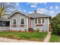 Charming single-story home with a well-manicured lawn, red front door and inviting curb appeal at 2472 Ames St, Edgewater, CO 80214