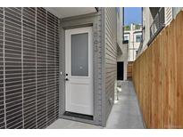 Modern home featuring a white front door with address number at 1563 N Hooker St, Denver, CO 80204