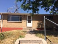 Modest brick home featuring a tidy front yard and a welcoming entrance, showcasing classic suburban charm at 1255 Yates St, Denver, CO 80204