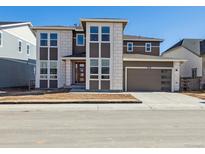 Two-story home with modern design, neutral color palette, and attached two-car garage at 8630 Pennycress Dr, Littleton, CO 80125