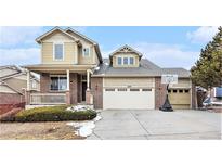 Charming two-story home with a brick and siding facade and attached two-car garage at 2835 S Jebel Way, Aurora, CO 80013