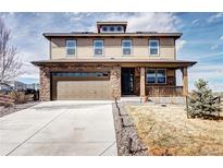 Inviting two-story home featuring a stone-accented facade and a covered front porch at 7353 S Queensburg St, Aurora, CO 80016