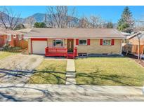 Charming home featuring a red trimmed brick exterior, lush lawn, and mountain views at 435 S 42Nd St, Boulder, CO 80305