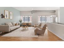 Inviting living room with modern furnishings, lots of natural light, and hardwood flooring at 70 W 6Th Ave # 109, Denver, CO 80204