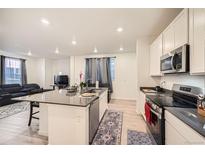 Modern kitchen with island, stainless steel appliances, and ample counter space at 677 Brookwood Dr, Lafayette, CO 80026